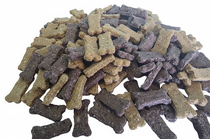 Assorted dog treats shaped like bones on a white background