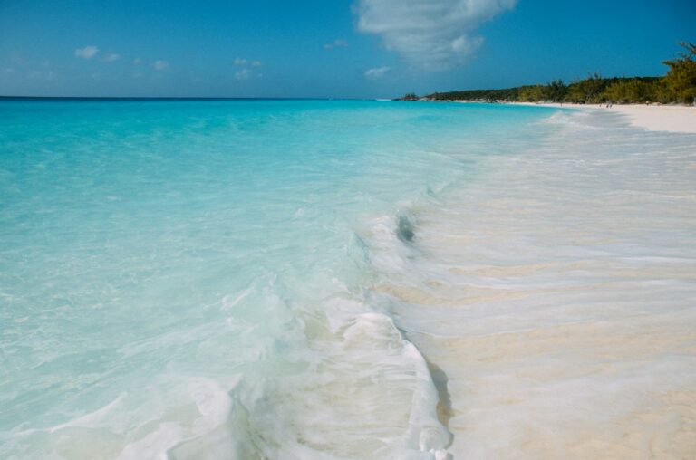 Turquoise summer ocean waves on a white sand beach