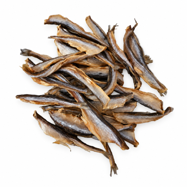 Pile of dehydrated smelts with silver skin and tan edges on white